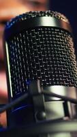 Vertical Artist records his voice on microphone in home studio singing a song composed by him. Skilled musician using recordings and lyrics to edit in post production, mixing and mastering session. Camera B. video