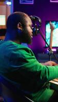 Vertical Talented artist composing new lyrics for his tracks and recording music with audio devices in his home studio. Singer composer writes melodic material by taking notes and creating rhymes or songs. Camera B. video