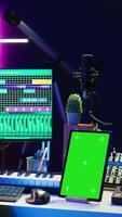 Vertical Songwriter composer mixing and mastering tracks next to green screen, operating on digital audio pc interface to add sound effects on new recordings. Technician in home studio. Camera B. video