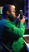Vertical Talented musician mixing and mastering songs on a console, twisting pre amp knobs to add sound effects in post production. Producer composing tracks for album, working in home studio. Camera B. video