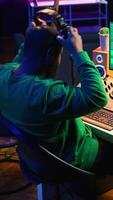 Vertical Skilled audio technician editing recorded tracks from an usb stick, using raw files to apply mix and master techniques. Artist producing music, adjusting volume levels on digital software. Camera B. video