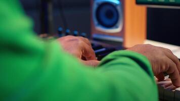 Sound engineer playing piano and mixing tunes on digital software, composing new songs and adding audio effects in post production. Artist composer creating soundtracks for music industry. Camera A. video