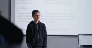 Portrait Of Smart Teen Boy Speaking In Front Of Classmates In Modern Classroom, Presenting Project video