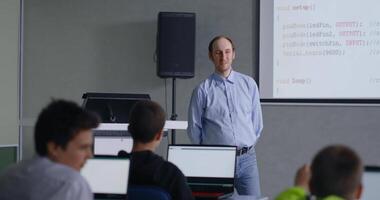 Teacher Of Computer Science And Programming Speaking In Classroom, Pupils Listening To Him video