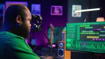 Music composer plays electronic keyboard piano keys and recording new tracks, creating audio recordings before launching music. Artist producer uses synthesizer, post production. Camera B. video