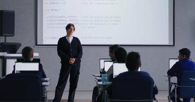 Young Student Speaking In Front Classmates In Computer-Based Classroom, Display With Presentation video