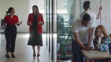 A diverse group of colleagues collaborates using laptops, mobiles, and tablets to tackle business challenges and enhance productivity through teamwork and innovative technology. video