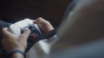 A business company's director takes a break from work in a modern office and indulges in gaming, using a joystick to play games on a TV, combining leisure and relaxation with a dash of office video