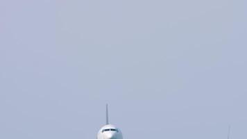 Airliner approaching to landing overhead. Footage of an airliner flying. Airplane in the sky, bottom view. Travel concept video