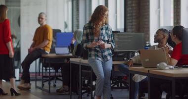 A diverse group of business colleagues engage in discussions about various business challenges, surrounded by their coworkers in a modern startup office, showcasing teamwork, innovation, and problem video