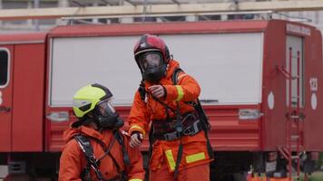 A group of specialized firefighters employs a thermal camera to locate and assess dangerous fire areas, demonstrating their advanced technology and expertise in effectively combating high-temperature video