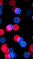 A colorful display of abstract bokeh lights in red and blue creates a stunning visual video