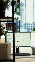 Vertical High end company office with a computer showing detailed data insights, executive business meetings or financial planning in a boardroom. Project development in a modern workspace. video