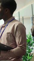 Vertical Teammates assembling in a boardroom to go over their analysis results after examining graphic representations and feedback from stakeholders. Staff and team leader exchange new ideas. Camera A. video