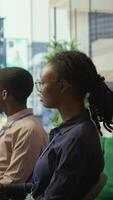 Vertical Diverse work team collaborating on project management tasks, utilizing smart technology and detailed analytics to optimize resource allocation and ensure enterprise objectives. Camera B. video