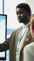 Diverse marketing team presenting a detailed reports analysis of recent campaigns, utilizing infographics and digital marketing insights to optimize future strategies and improve ROI. Camera A. video
