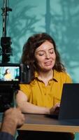 Vertical Content creator using production camera gear to film motivational type for fans. Online show host using professional microphone to share inspiring quotes to viewers, camera A video