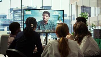 CEO leading a meeting on online teleconference call in the boardroom, discussing about latest updates with his employees. Business experts review financial planning to drive company growth. Camera B. video