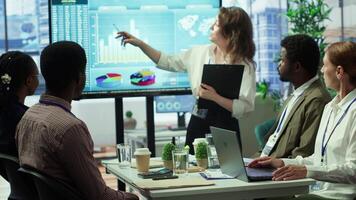 Team of business colleagues study feedback on projects for future improvements, developing marketing strategies in coworking space meeting room. Startup organization planning activity. Camera A. video
