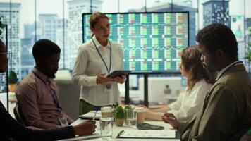 Business coworkers engaging in a collaborative startup meeting, utilizing interactive board and tablet with data visualization to brainstorm solutions and enhance project outcomes. Camera B. video
