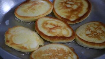 Pancakes are fried in oil in a pan. Breakfast at home video