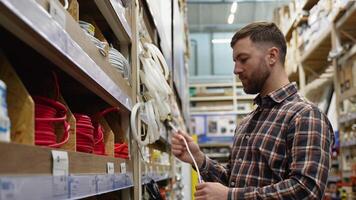 A man sells electrical or ethernet cables in a hardware store video
