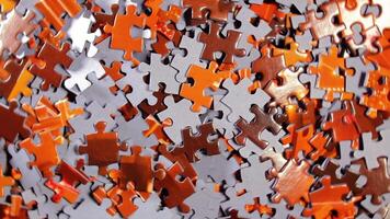 Background of Colored Puzzle Pieces that Rotating Counterclockwise - Top View. Texture of Incomplete Red and Grey Jigsaw Puzzle - Left Rotation video