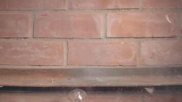 Firecracker Exploaded in Wineglass Against a Brick Wall - Super Slow Motion. The Blast Wave of a Petard Damaged the Glass and Many Small Fragments of Glass Flew in Different Directions - Static Shot video
