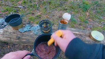 Camp Food. Cooking in a Hike Using a Small Cook Set - First Person View, Wide Angle. Food on the Trip. Traveler in a Spring Forest. Tourist in a Travel is Heating Food - POV Shot. video