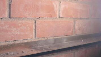 The Petard Was Placed on a Metal Surface by the Hand Than Explode Against a Brick Wall. Many Small Particles Flew in a Different Directions - Static Shot video