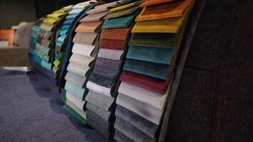 Fabric and textiles samples in a factory shop or store. Different colors and patterns on the market video