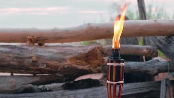 Tropical Bamboo Torch Burning in the Beach at Summer Evening. Decorative Candle Has a Massive Orange Flame Using Oil Fuel or Kerosene - Slow Motion. Static Shot video