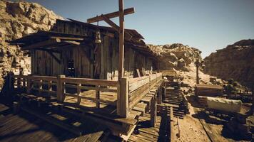 Rustic wooden structure in a desert landscape under a clear blue sky video