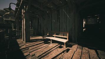 A rustic wooden bench under soft lighting in an old wooden structure video