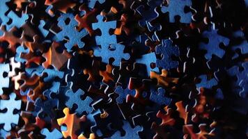 Background of Colored Puzzle Pieces that Rotating Clockwise - Top View. Texture of Incomplete Red and Blue Jigsaw Puzzle with Low Key Light - Right Rotation video