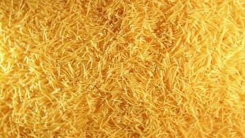 Background of Uncooked Golden Noodles that Rotating Clockwise - Top View. Texture of Dry Vermicelli Turning Around. Raw Pasta - Right Rotation video
