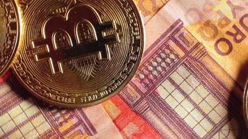 Bitcoin Coins on the 50 Euro Banknotes - Top View, Macro. Euro Money Cash and Cryptocurrency. A Lot of Fifty Euro Bills. Finances, Blockchain and Electronic Money Concept - Slow Rotation Left video