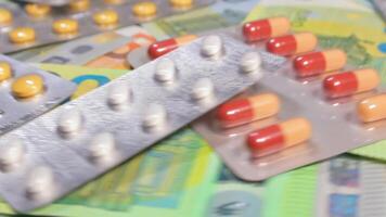 Pharmaceutical Industry and Expensive Medicines. Colored Pills, Tablets and Capsules on the Different Euro Banknotes - Rotating, Close-Up. Pills and Cash. Money and Drug Addiction. Buying Medicines video