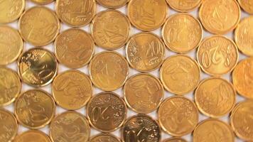 20 Euro Cent Coins, Rotating Money Background - Top View. Euro Money Currency. A Lot of Twenty Cent Cash. Golden Eurocents. Business, Finances and Money Saving Concept - Slow Rotation Left video