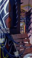 Vertical Close up of pizza boxes leftover by teenagers using abandoned building with graffiti drawings to hang out. Desolate defaced location left in messy state by edgy teens, concept of urban culture video