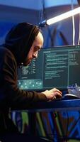 Vertical Hacker in graffiti painted warehouse celebrating after successfully tricking internet users into revealing sensitive information. Cheerful cybercriminal excited after stealing passwords video