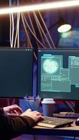 Vertical Hacker happy after successfully doing computer sabotage using encryption trojan ransomware in hidden base. Cybercriminal demands ransom money from victims after gaining access to their data, camera B video
