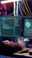 Vertical Hacker in dark underground warehouse trying to steal valuable data by targeting governmental websites but getting access denied error message, having cyber attacks rejected, dolly in close up shot video