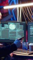Vertical Hacker arriving in secret underground base with SSD containing data from victim after tricking it into installing ransomware program he developed. Man satisfied with his criminal plan, camera B video