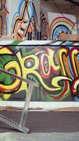 Vertical Empty vandalized property with graffiti paintings on walls, concept of alternative lifestyle. City slums ghetto location used as crime base of operations by hooligans doing street art, panning shot video