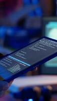 Vertical Hacker using VPN as anonymity tool to mask his online identity while committing data breaches using tablet. Cybercriminal in bunker masking his location, hacking with device, camera B close up video