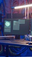Vertical Hooded hacker arriving in hidden underground shelter, prepared to launch DDoS attack on websites. Cybercriminal starting work on script that can crash businesses servers, camera B video