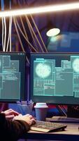 Vertical Hacker in hidden base successfully getting past anti tamper measures implemented by companies to protect products. Cracker pirating software and game releases, camera B video