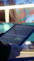 Vertical Hacker using VPN as anonymity tool to mask his online identity while committing data breaches using tablet. Cybercriminal in bunker masking his location, hacking with device, camera A close up video