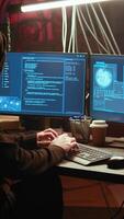 Vertical Hacker in underground bunker takes advantage of security breach after gaining unauthorized access to system. Rogue programmer hacking network to steal government data, zoom in close up shot video